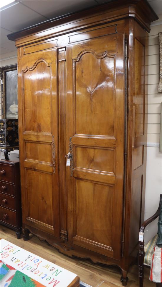 A 19th century French walnut armoire enclosed by a pair of shaped panelled doors H.252cm